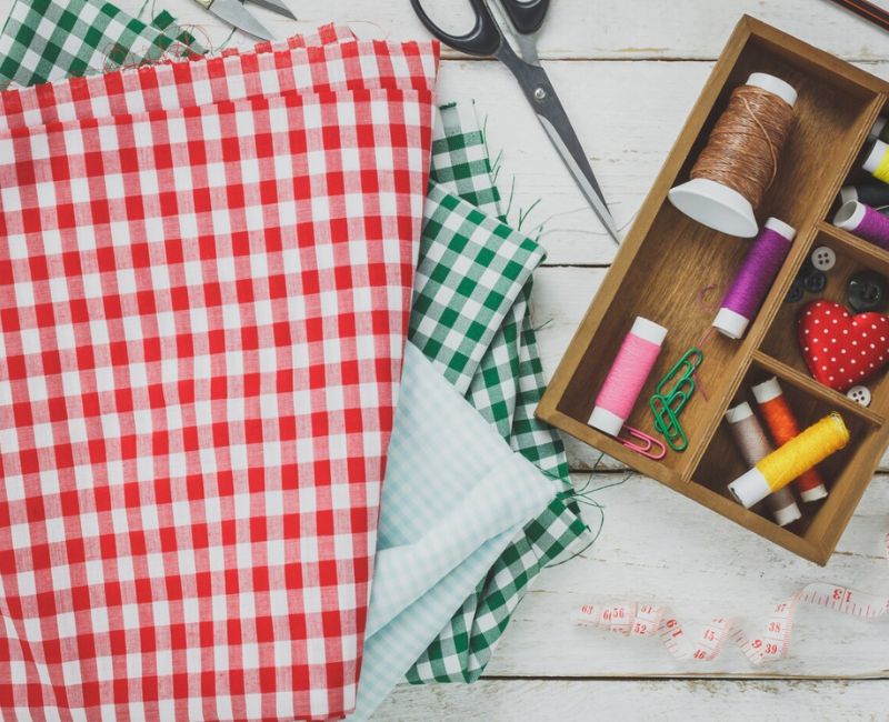 collection of dish towels hanging on hooks in a modern kitchen, showcasing various designs and a contemporary setting. collection of dish towels hanging on hooks in a modern kitchen, showcasing various designs and a contemporary setting.