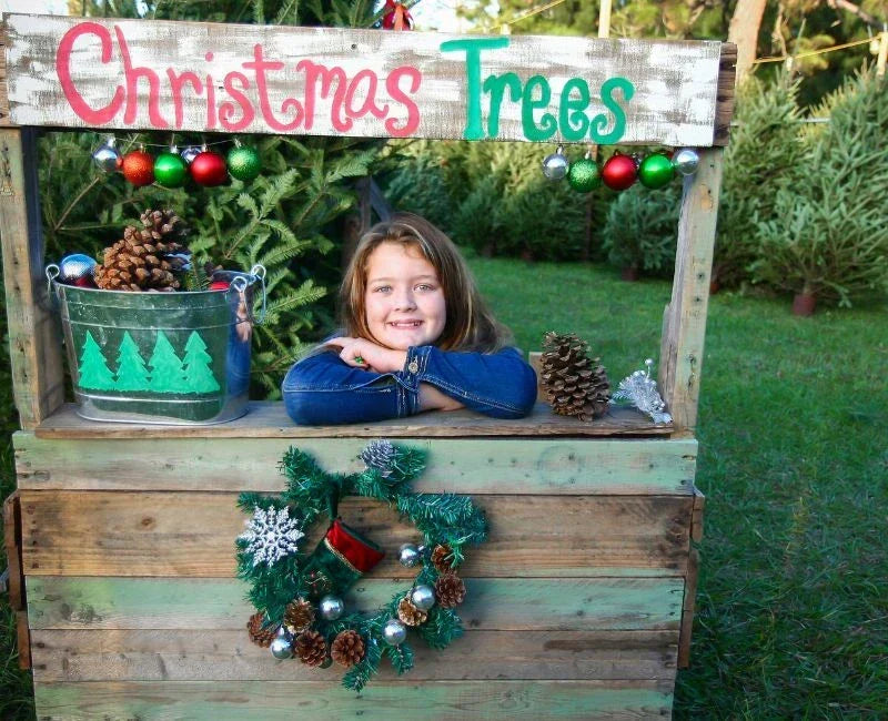 a small girl selling christmas trees a small girl selling christmas trees