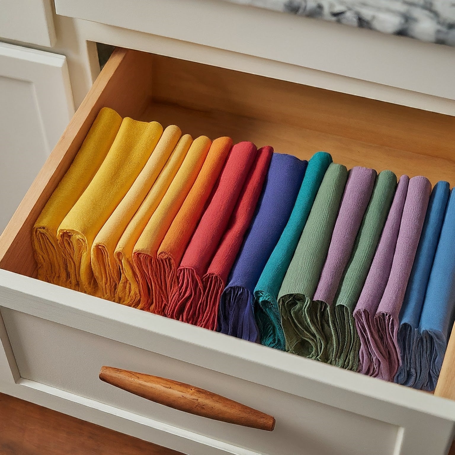 A stack of high-quality cloth napkins in various vibrant colors, neatly folded and arranged on a table. A stack of high-quality cloth napkins in various vibrant colors, neatly folded and arranged on a table.