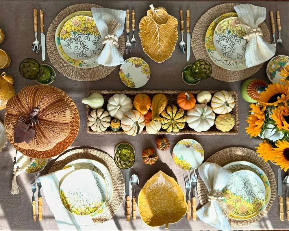 Fall table decor with pumpkins, sunflower centerpiece, leaf plates, and linen napkins Fall table decor with pumpkins, sunflower centerpiece, leaf plates, and linen napkins