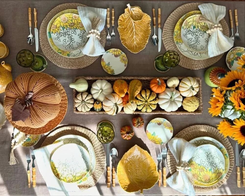 Fall table decor with pumpkins, sunflower centerpiece, leaf plates, and linen napkins Fall table decor with pumpkins, sunflower centerpiece, leaf plates, and linen napkins