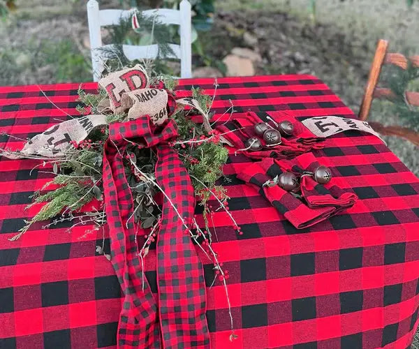 Dining room decorated for Halloween with a black and red checkered tablecloth, pumpkin-shaped candles, and Halloween-themed dishes. Dining room decorated for Halloween with a black and red checkered tablecloth, pumpkin-shaped candles, and Halloween-themed dishes.