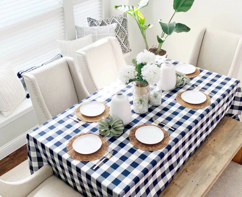 rectangle table covered with a black and white checkered tablecloth, specifically styled for a blog. The setting is designed to project a chic and contemporary look. rectangle table covered with a black and white checkered tablecloth, specifically styled for a blog. The setting is designed to project a chic and contemporary look.