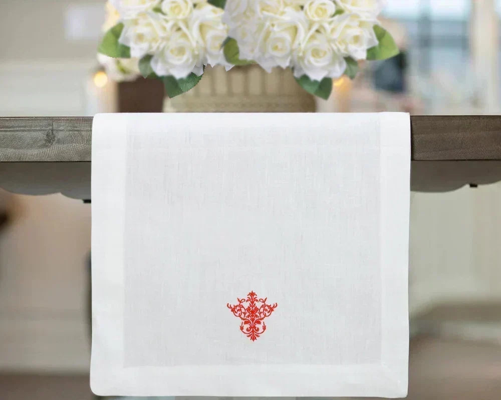Table runner placed lengthwise across the center of a dining table Table runner placed lengthwise across the center of a dining table