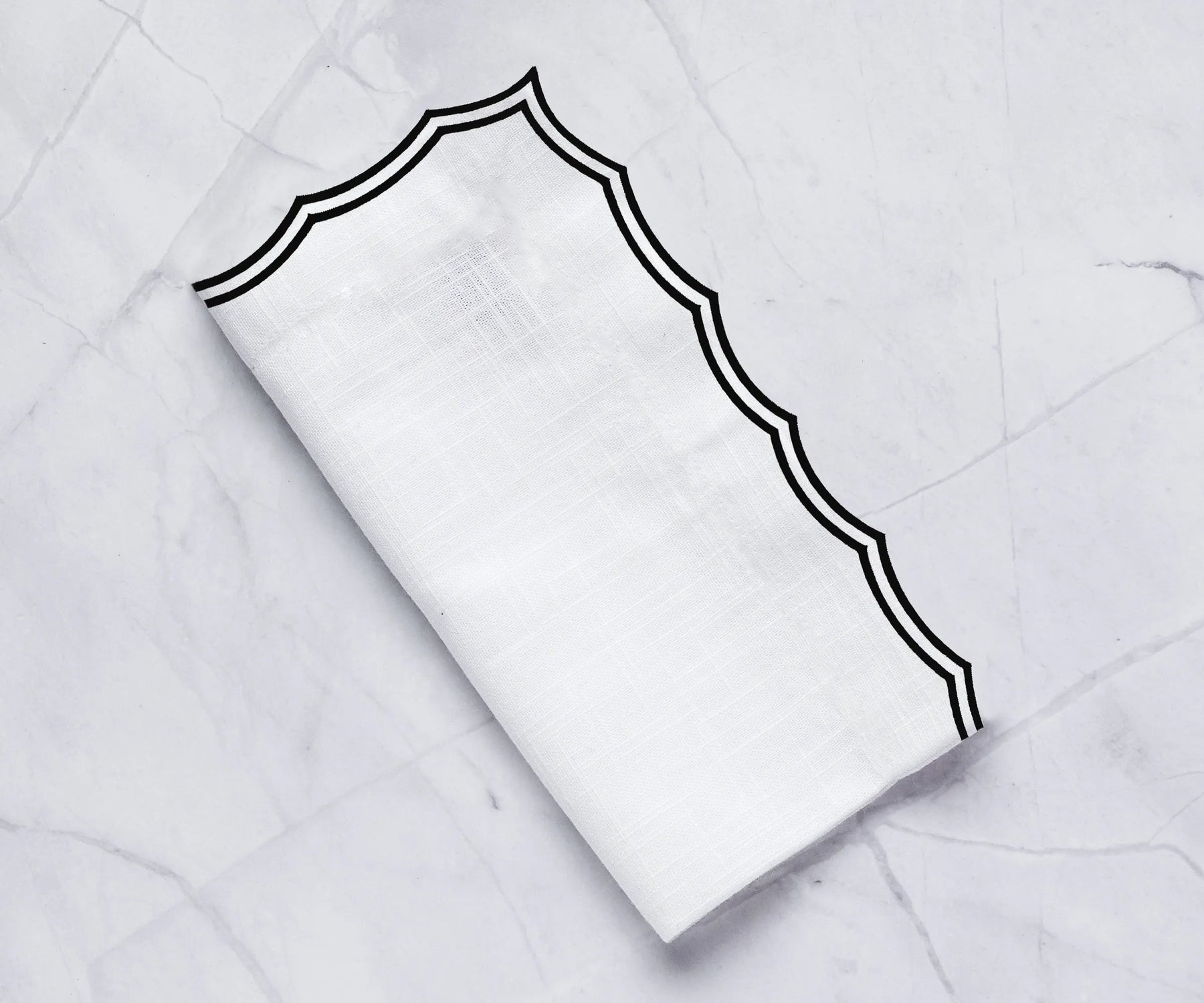 Elegant embroidered dinner napkins on a formal dining table Elegant embroidered dinner napkins on a formal dining table