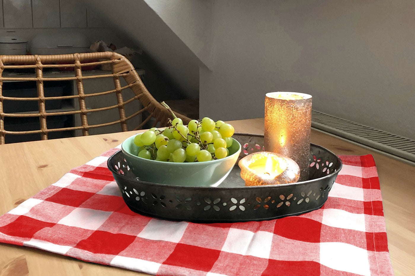 Tray with grapes and candles on a red and white checkered tablecloth. Tray with grapes and candles on a red and white checkered tablecloth.