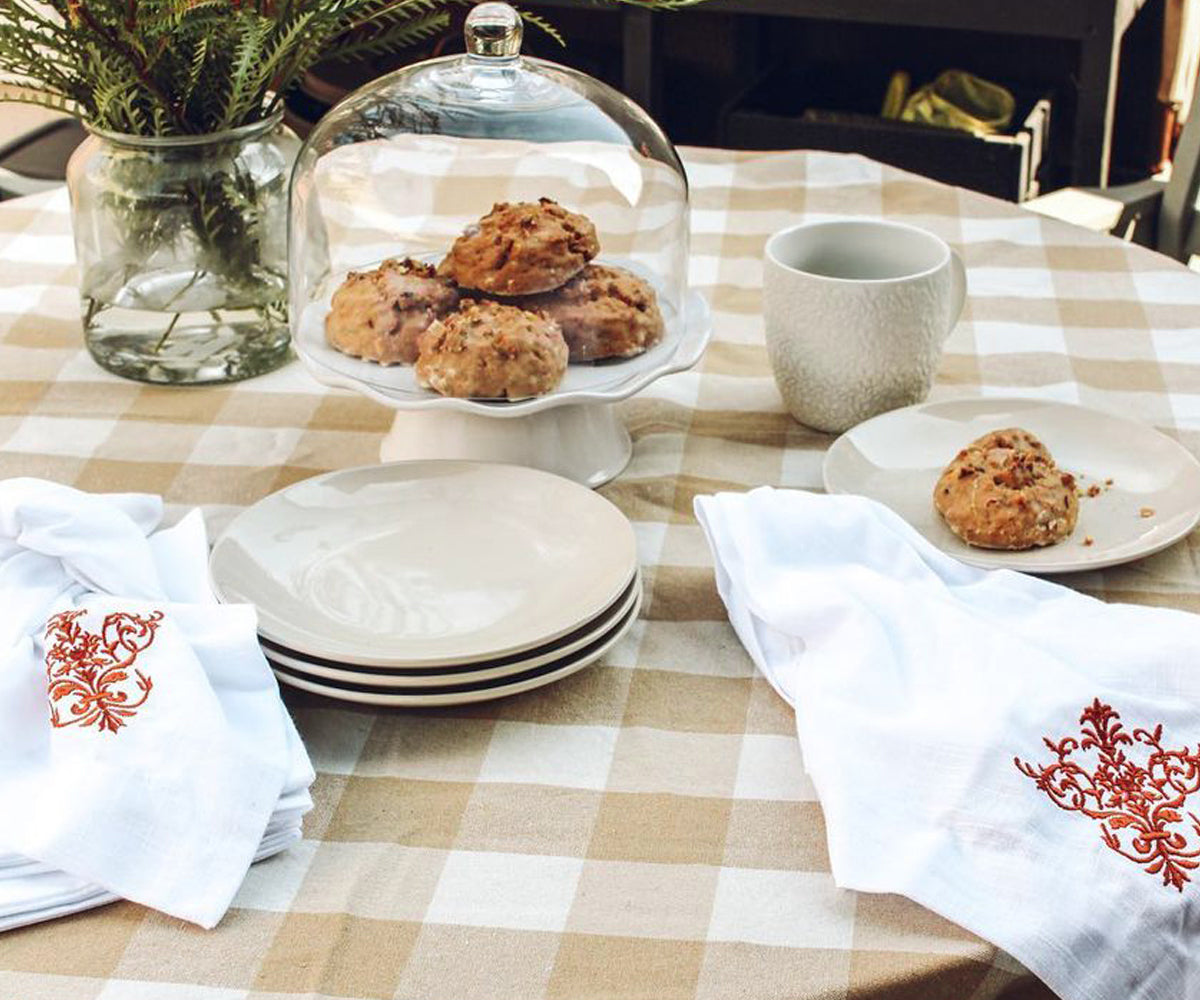 Neutral checkered tablecloth with farmhouse-style dining chairs Neutral checkered tablecloth with farmhouse-style dining chairs