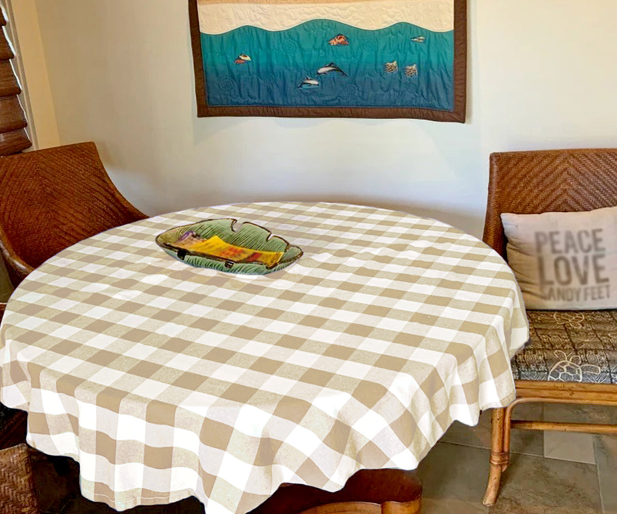 Small dining space with beige plaid tablecloth and white chairs Small dining space with beige plaid tablecloth and white chairs