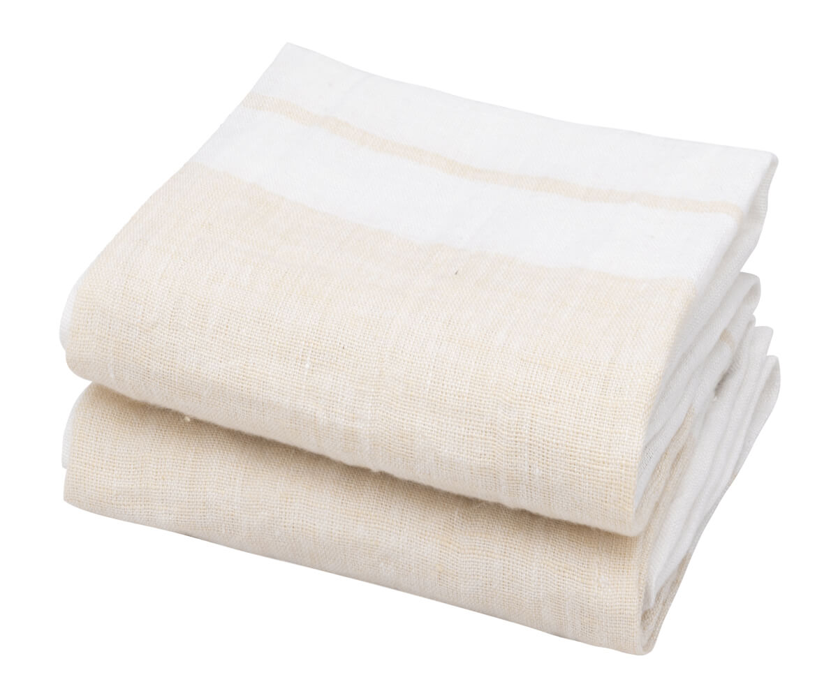 A beige linen kitchen towel is displayed on a table with a wooden plate on top of it. A beige linen kitchen towel is displayed on a table with a wooden plate on top of it.