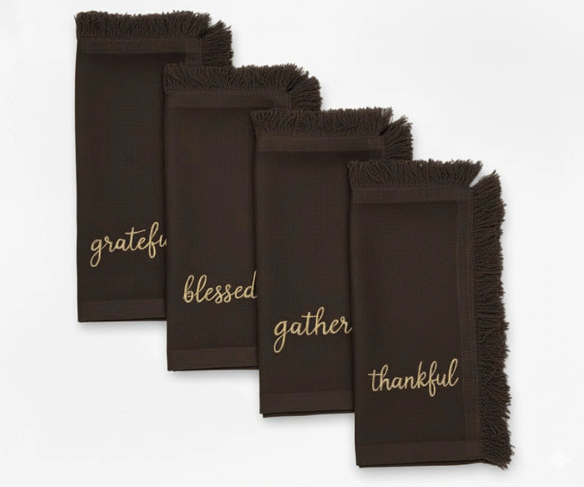 Elegant brown embroidered napkins with gold lettering and fringed edges – perfect for Thanksgiving dining Elegant brown embroidered napkins with gold lettering and fringed edges – perfect for Thanksgiving dining