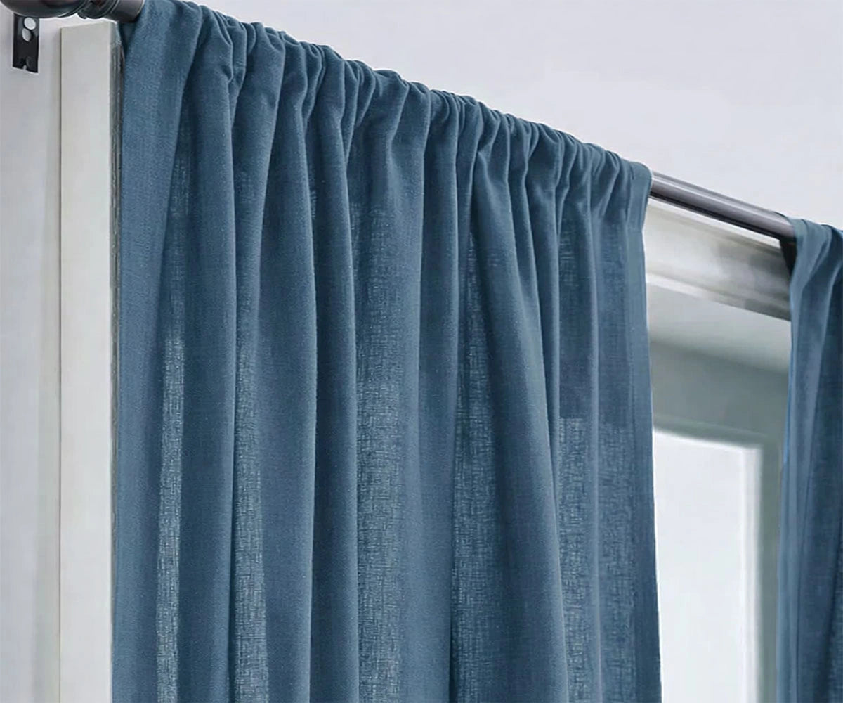Dusty blue linen window curtains with a soft, calming tone, ideal for coastal, modern, or minimalist living room décor. Dusty blue linen window curtains with a soft, calming tone, ideal for coastal, modern, or minimalist living room décor.