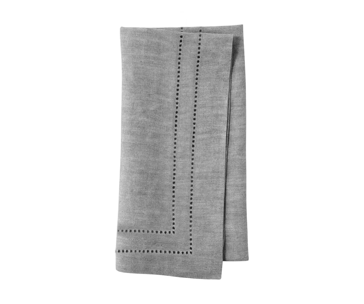 Elegant charcoal grey linen napkins with double hemstitch border – folded set on dining table Elegant charcoal grey linen napkins with double hemstitch border – folded set on dining table