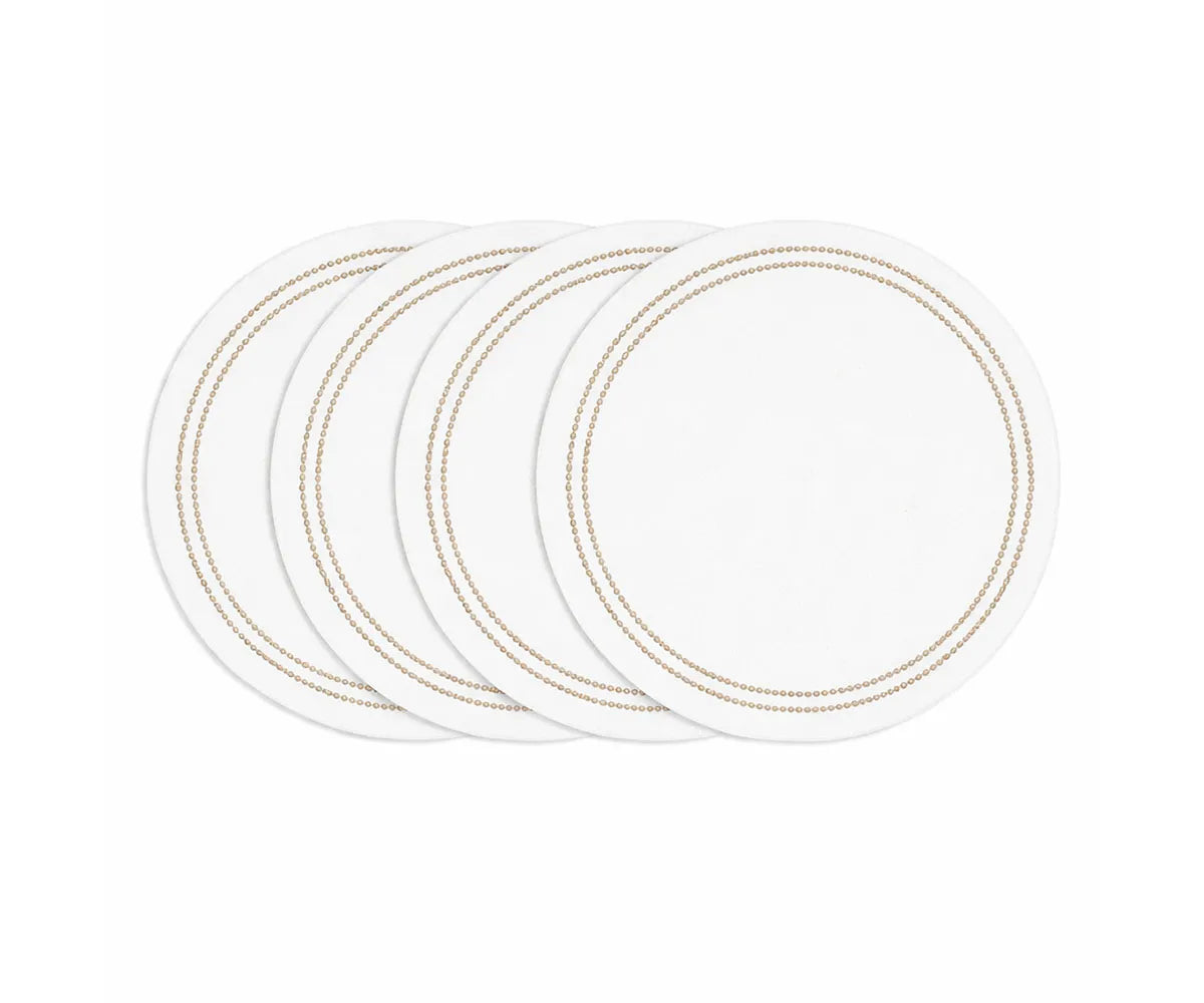 Natural round cotton placemat with white base and detailed embroidery on dining table Natural round cotton placemat with white base and detailed embroidery on dining table