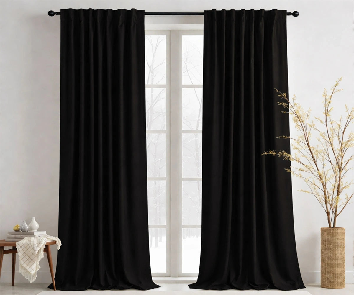 Black cotton curtains hanging in a modern living room Black cotton curtains hanging in a modern living room
