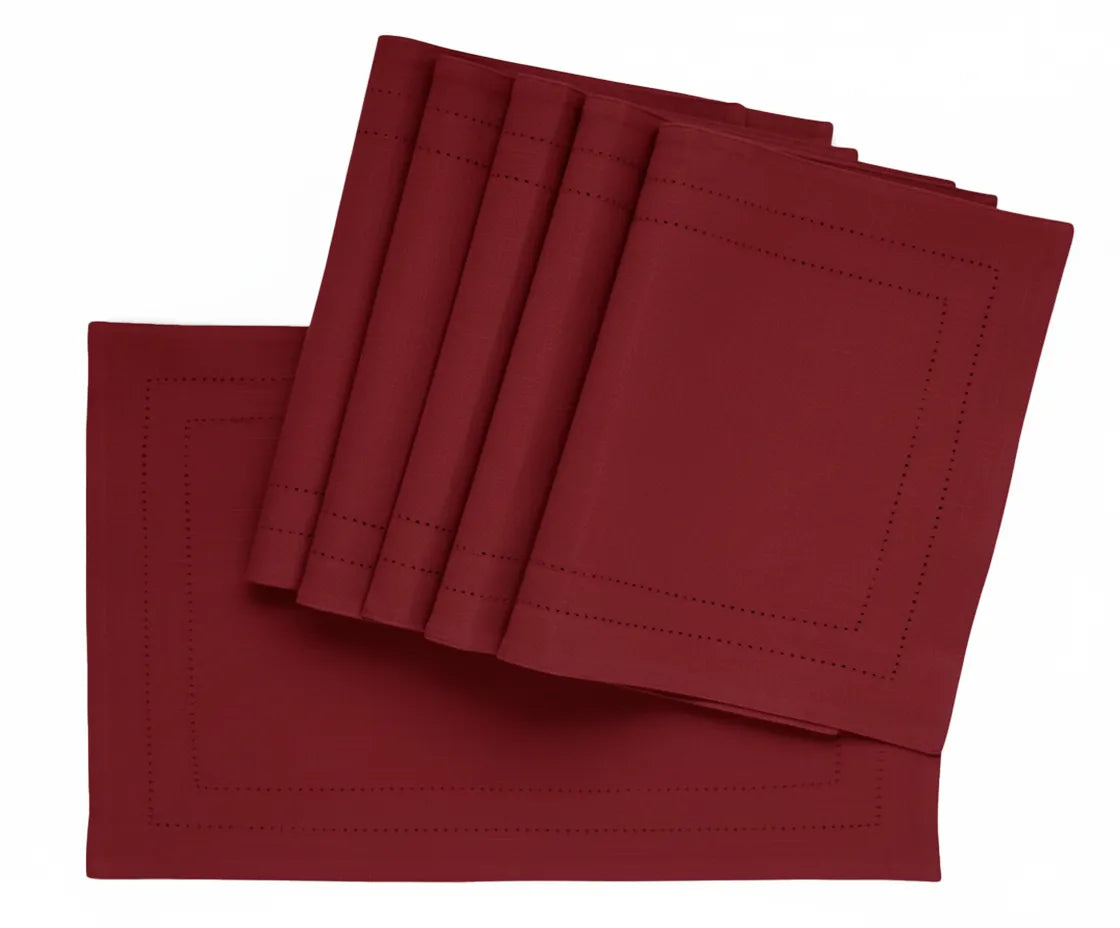 Dark red double hemstitched cotton rectangle placemat on dining table Dark red double hemstitched cotton rectangle placemat on dining table