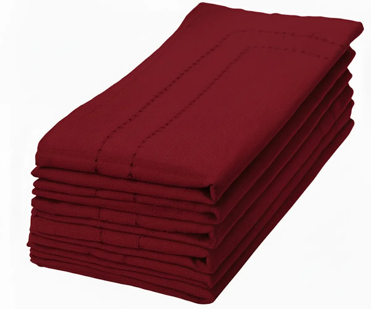 Dark red hemstitch cotton napkin adding a rich, sophisticated touch to holiday and event tables Dark red hemstitch cotton napkin adding a rich, sophisticated touch to holiday and event tables