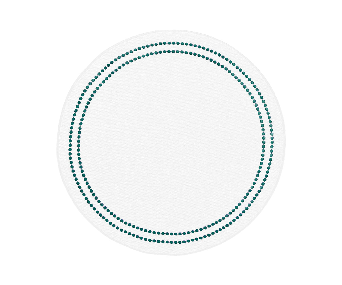 Green round cotton placemats with embroidered design and pearls accents on a dining table Green round cotton placemats with embroidered design and pearls accents on a dining table