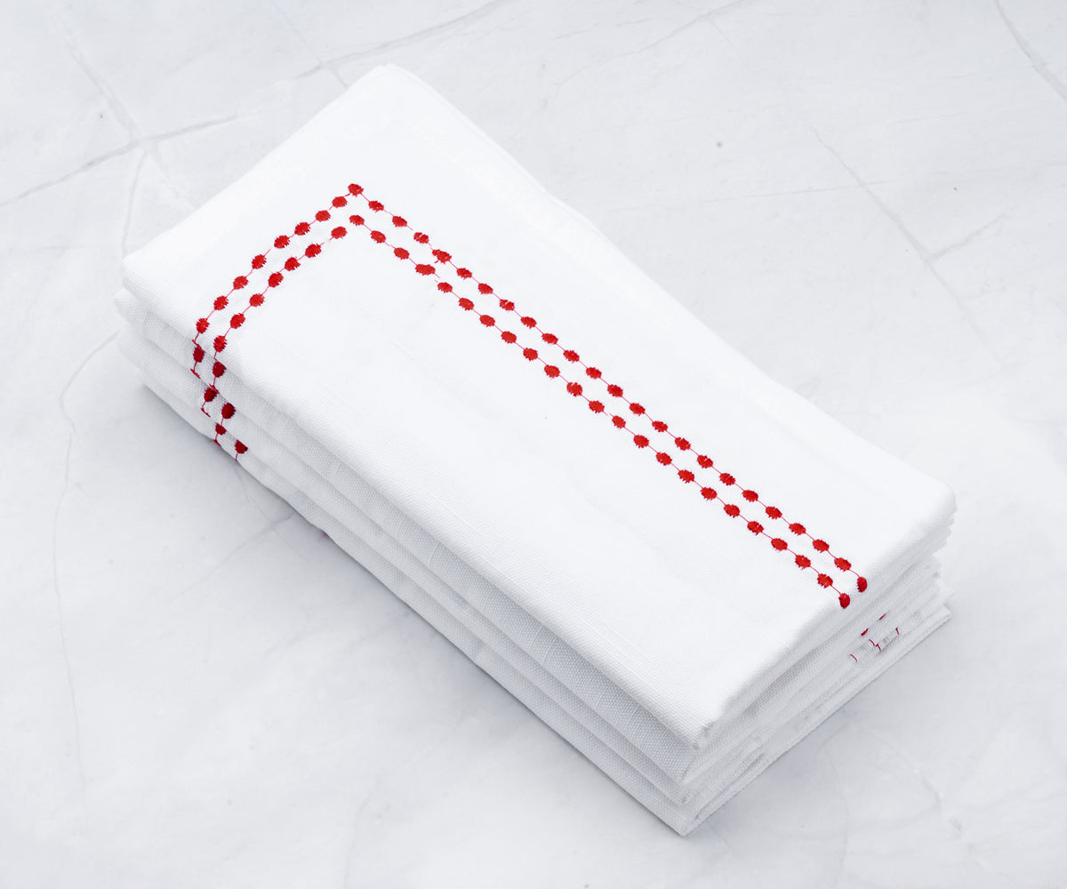 Delicately embroidered napkins with charming dots, adding a touch of sophistication to your dining experience.