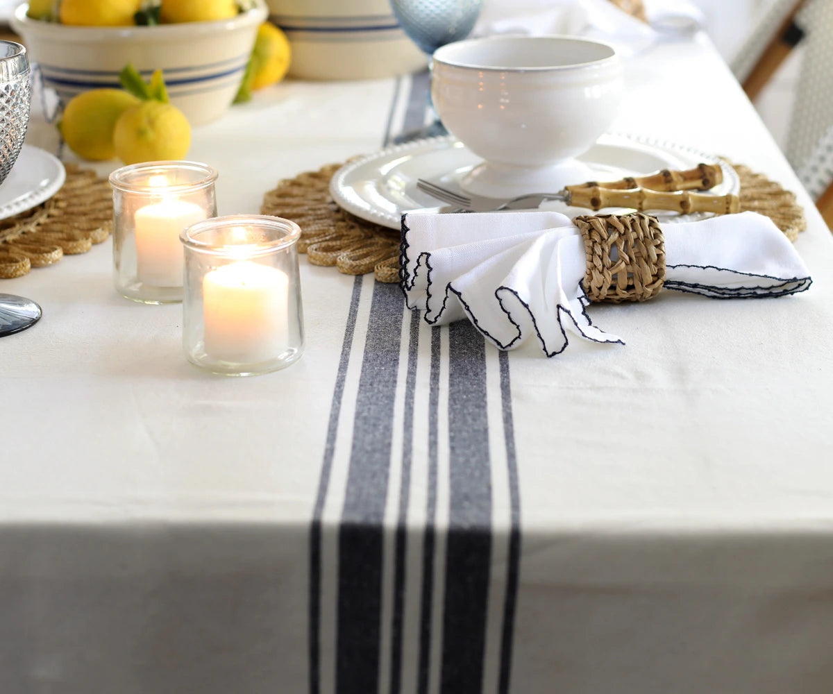 Striped cotton rectangle tablecloth on dining table in natural color Striped cotton rectangle tablecloth on dining table in natural color