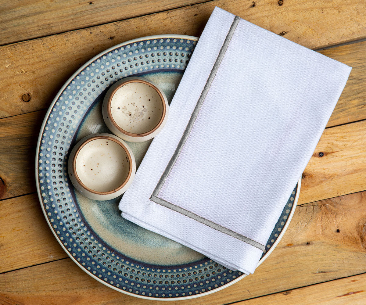 Grey cloth napkins arranged neatly, adding a pop of color to the table.