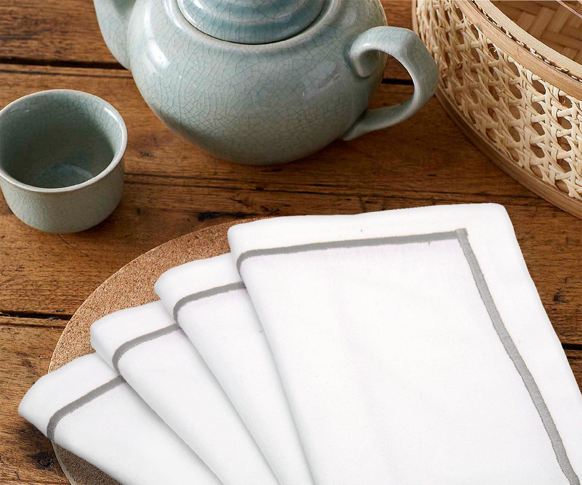Collection of cloth table napkins in various colors and textures.