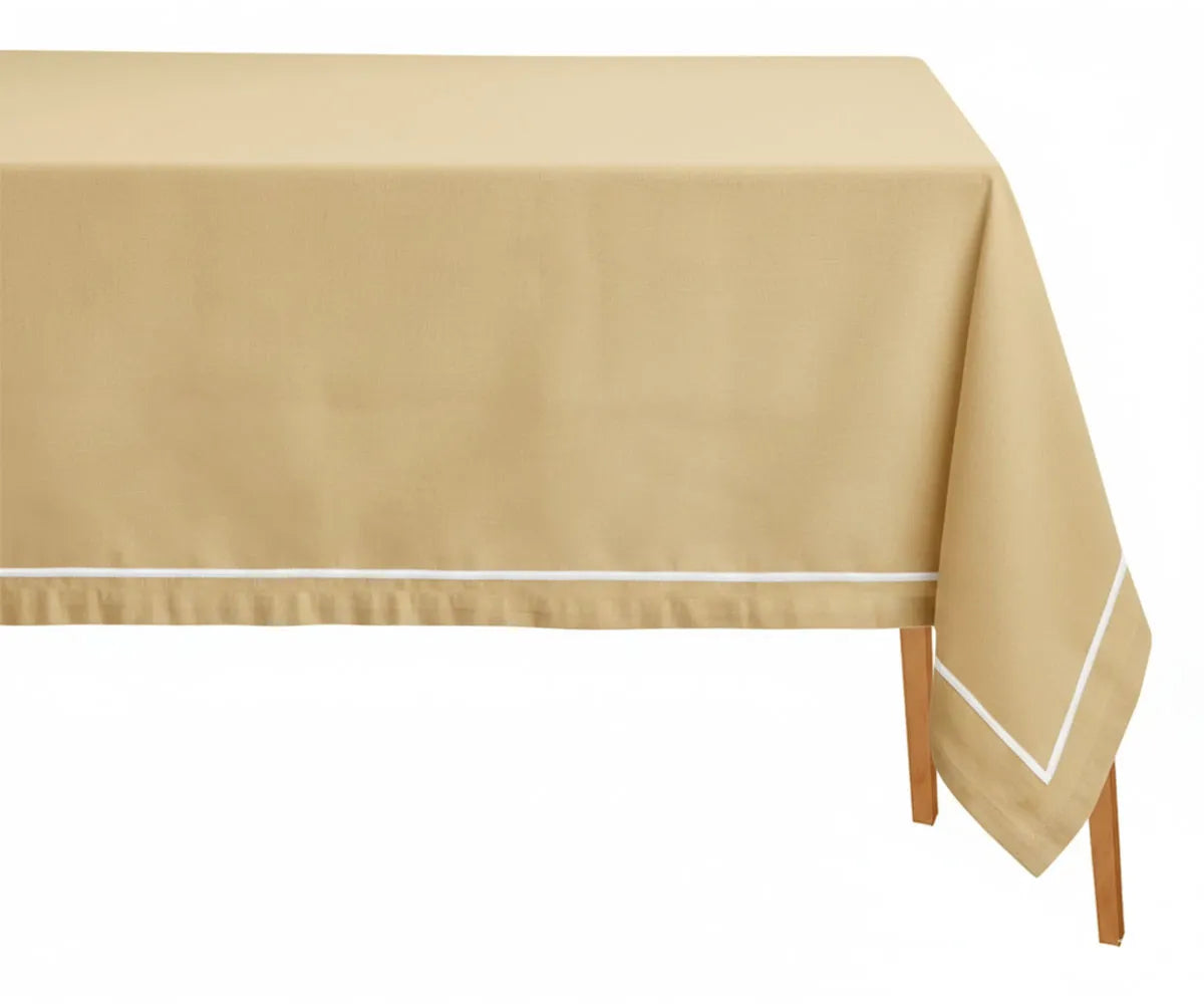 Gold rectangle tablecloth with white embroidery pattern on dining table Gold rectangle tablecloth with white embroidery pattern on dining table