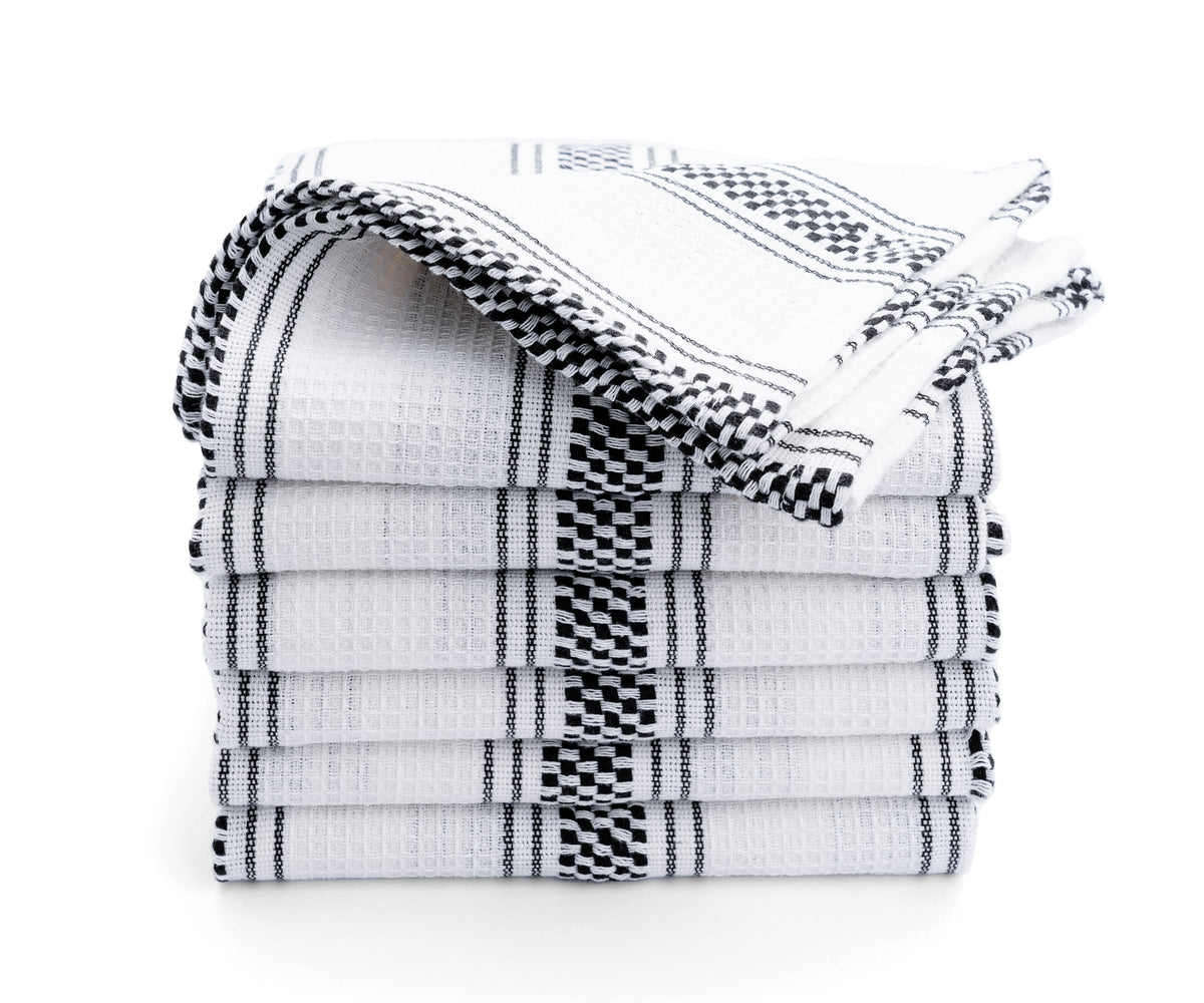 A pile of black kitchen hand towels with white stripes A pile of black kitchen hand towels with white stripes