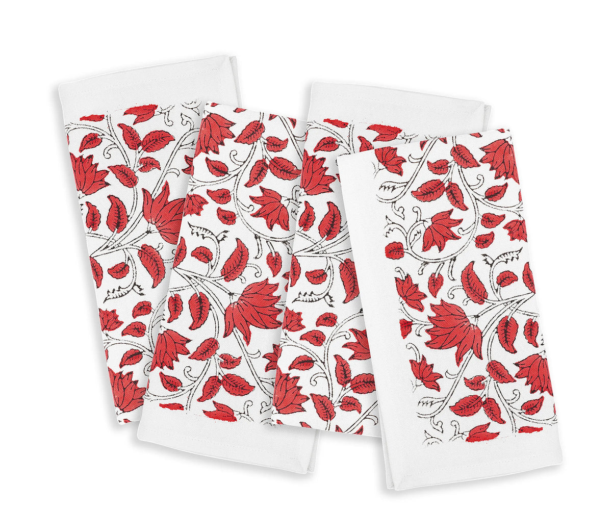 Floral cotton napkins neatly folded on a rustic dinner table	 Floral cotton napkins neatly folded on a rustic dinner table