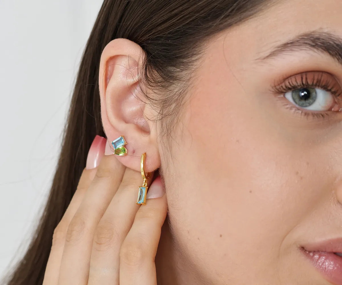 Versatile huggie earrings with a sleek dangling charm Versatile huggie earrings with a sleek dangling charm