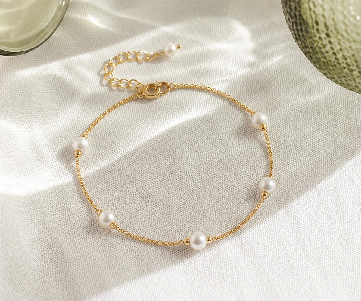 Pearl chain charm bracelet flat lay, gold plated anchor chain bracelet with freshwater pearls, minimalist jewelry for women Pearl chain charm bracelet flat lay, gold plated anchor chain bracelet with freshwater pearls, minimalist jewelry for women