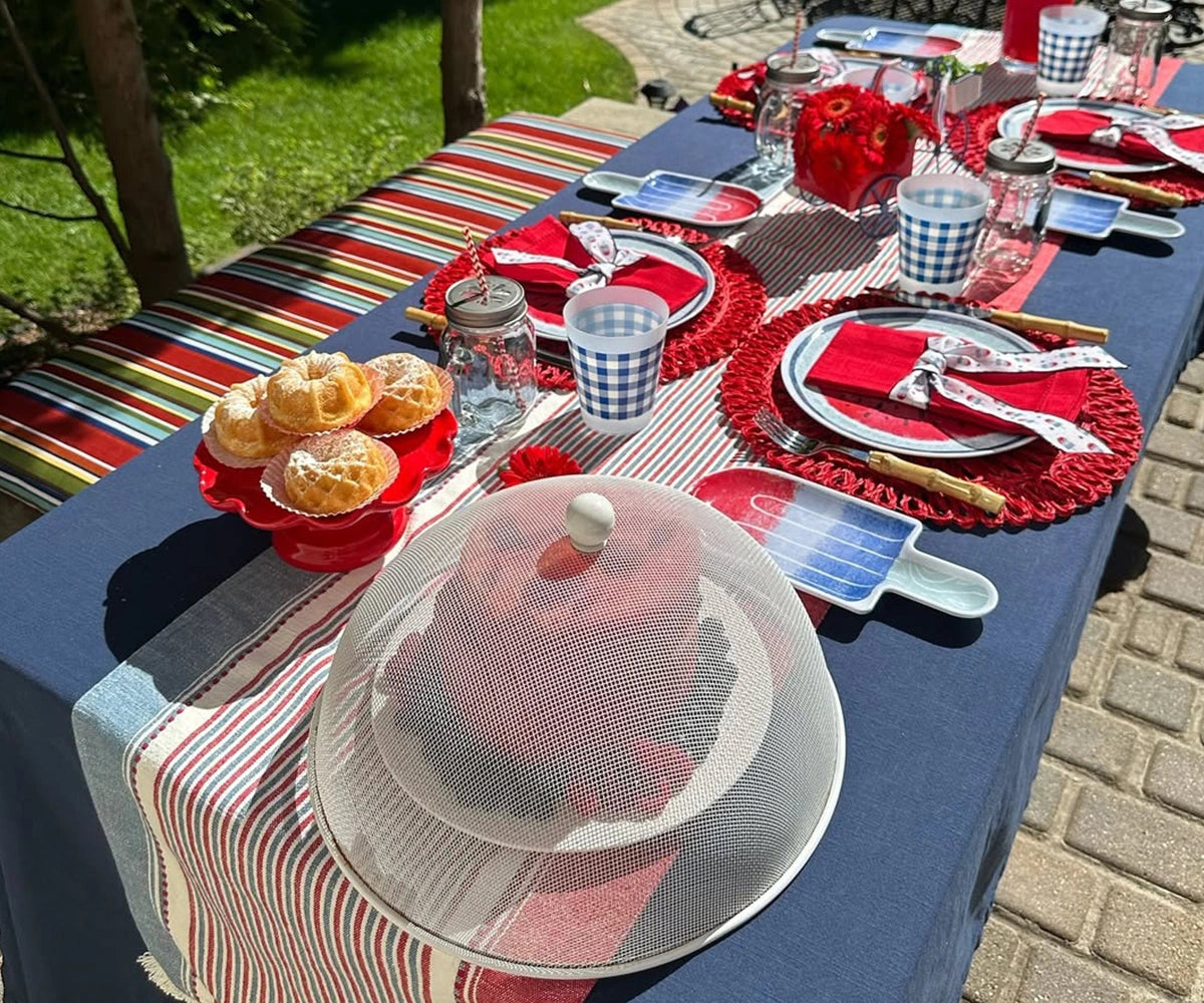 Elegant red cotton napkins with classic single hemstitch border, displayed in a stacked arrangement Elegant red cotton napkins with classic single hemstitch border, displayed in a stacked arrangement