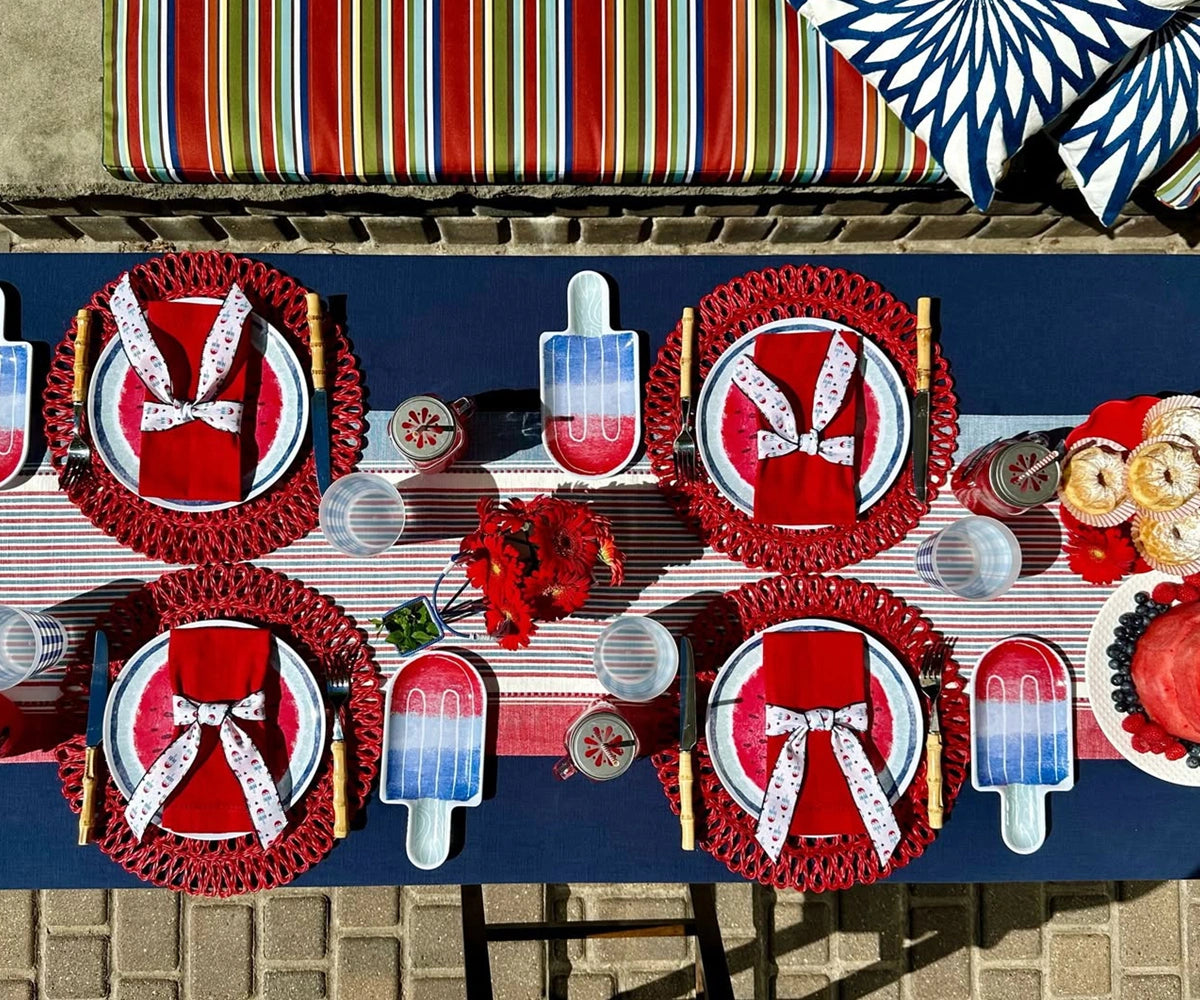 Stylish red dinner napkins with single hemstitch design, arranged on a dining table setting Stylish red dinner napkins with single hemstitch design, arranged on a dining table setting