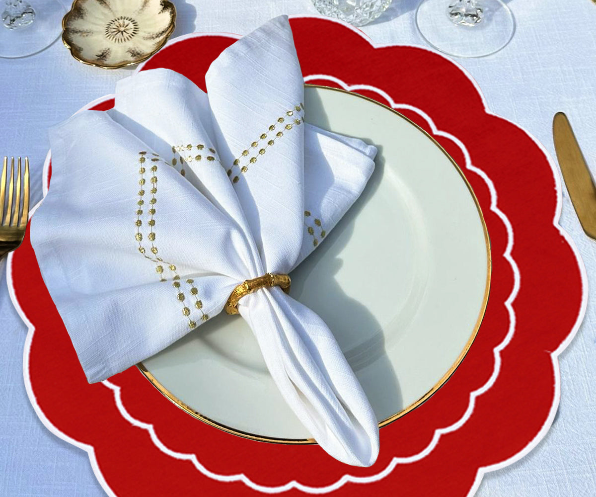 Round red placemats with a scallop pattern, providing a touch of sophistication and elegance to the table décor. Round red placemats with a scallop pattern, providing a touch of sophistication and elegance to the table décor.
