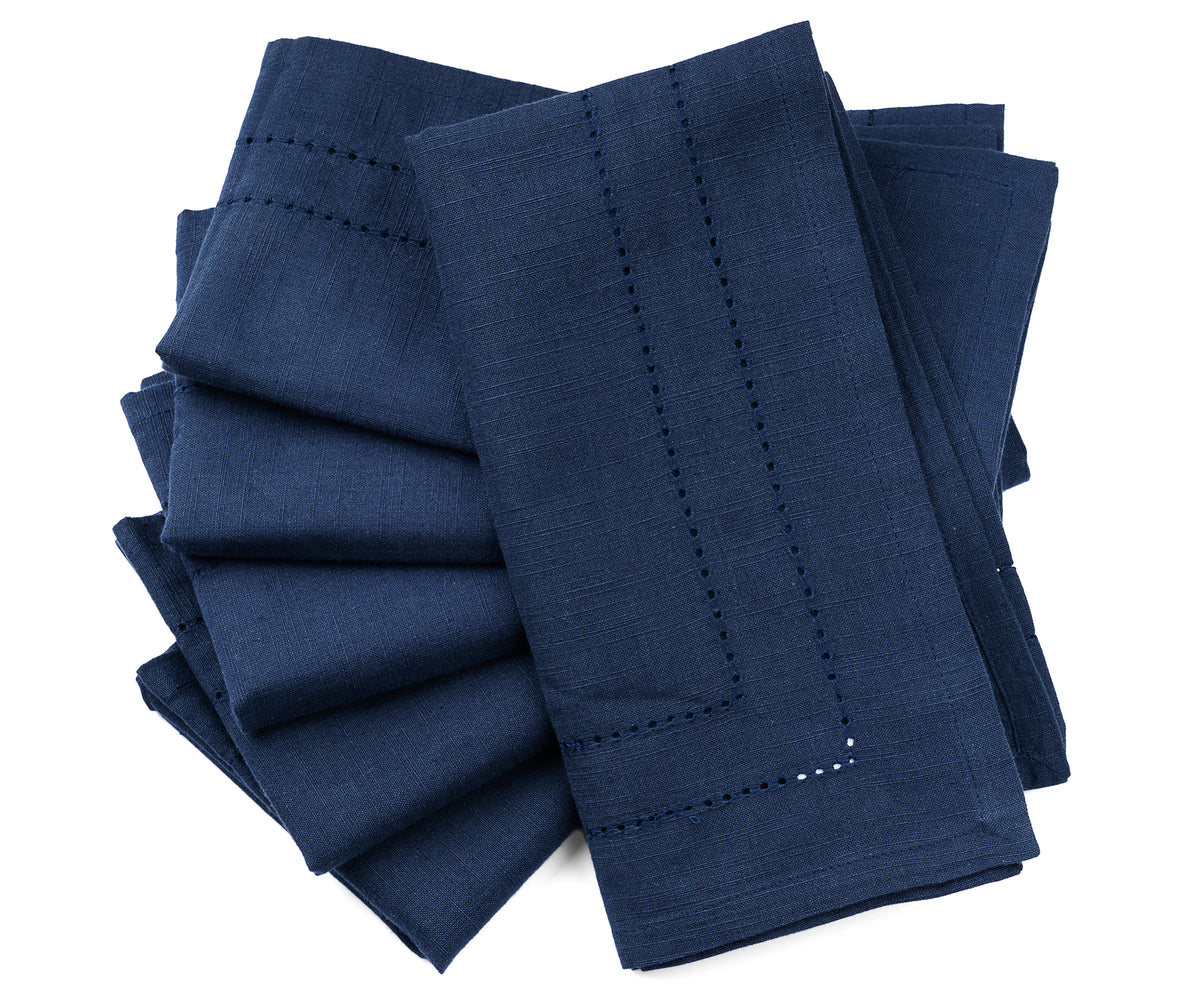 Luxurious navy blue Cloth Dinner Napkins with intricate white stitching, displayed elegantly Luxurious navy blue Cloth Dinner Napkins with intricate white stitching, displayed elegantly
