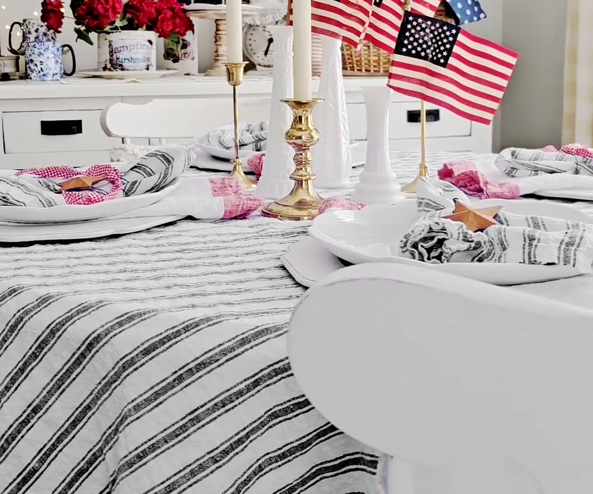 Minimalist dining room with a black linen tablecloth and simple decor Minimalist dining room with a black linen tablecloth and simple decor"