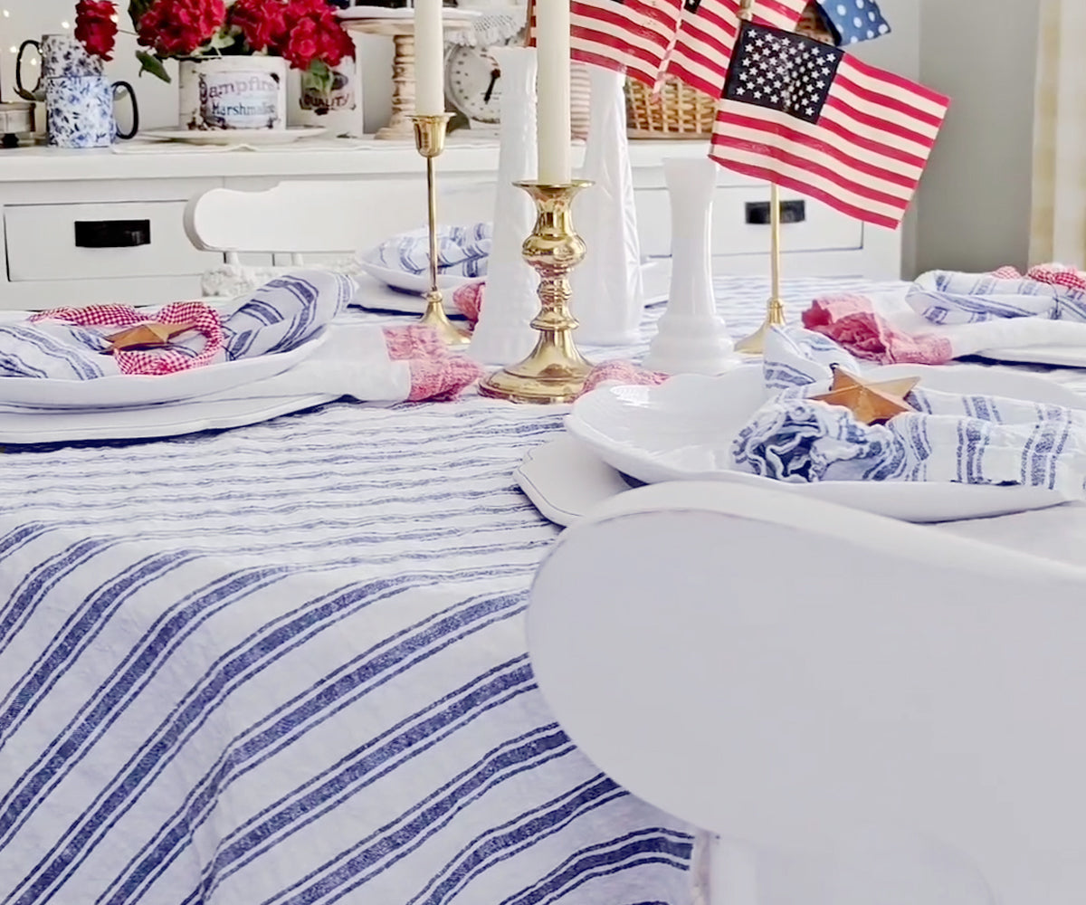 Minimalist dining room with a blue linen tablecloth and simple decor. Minimalist dining room with a blue linen tablecloth and simple decor.