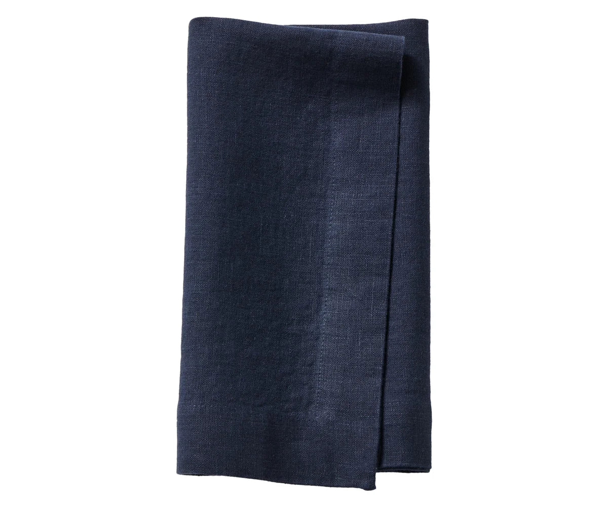 Indigo linen napkins on a holiday dinner table Indigo linen napkins on a holiday dinner table