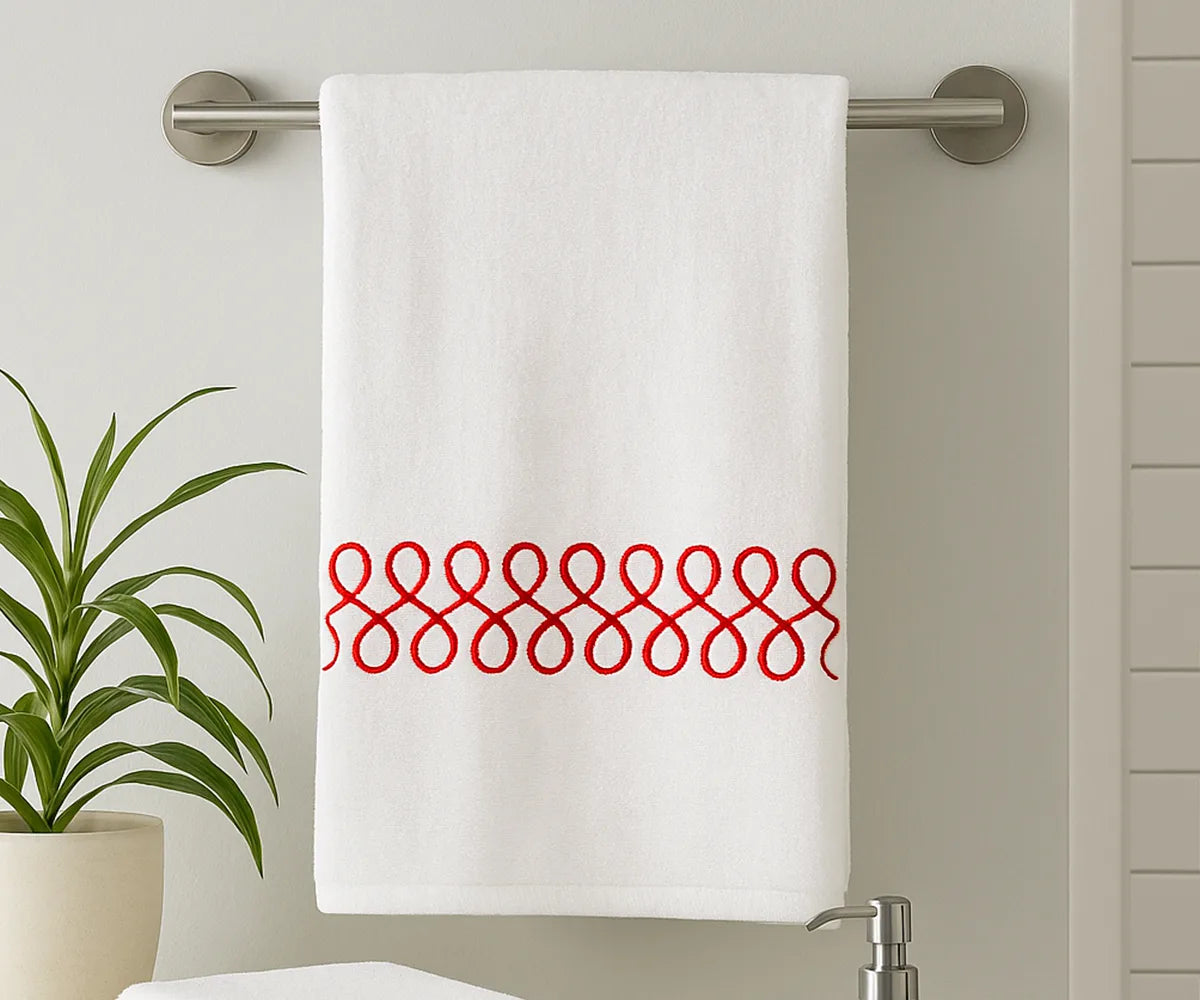 White cotton bath towel with red embroidered design, 100% cotton, soft and absorbent, perfect for spa-like comfort after showers or baths. White cotton bath towel with red embroidered design, 100% cotton, soft and absorbent, perfect for spa-like comfort after showers or baths.