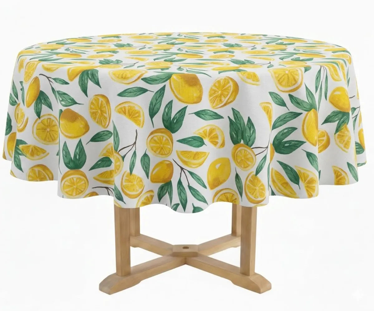 60-inch round cotton tablecloth with yellow lemon and green leaf print on white background, styled on an outdoor garden dining table with ceramic plates and rattan accents 60-inch round cotton tablecloth with yellow lemon and green leaf print on white background, styled on an outdoor garden dining table with ceramic plates and rattan accents
