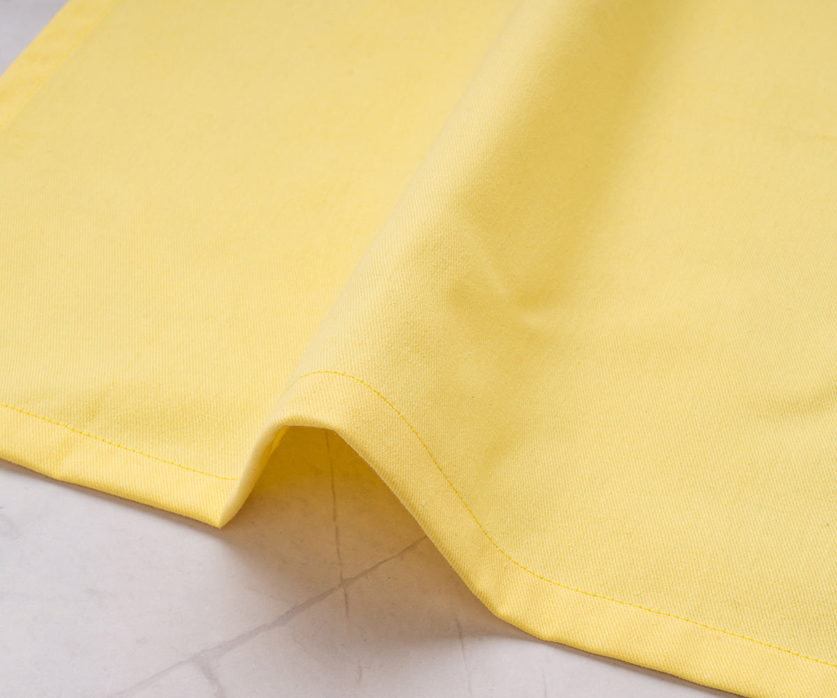 Set of lemon yellow fabric napkins arranged for elegant table decor. Set of lemon yellow fabric napkins arranged for elegant table decor.