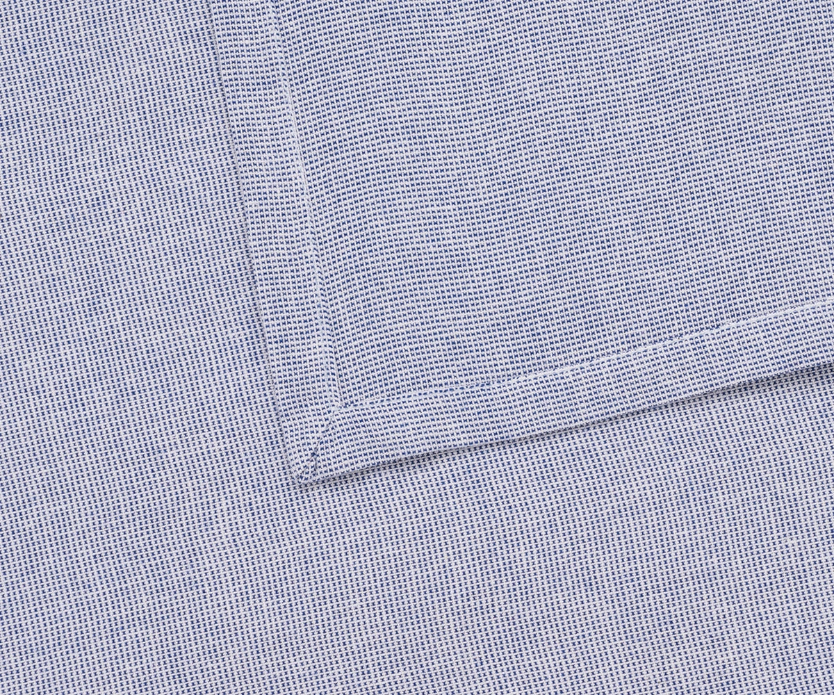 Elegant light blue table napkin styled with floral accents for a wedding tablescape. Elegant light blue table napkin styled with floral accents for a wedding tablescape.