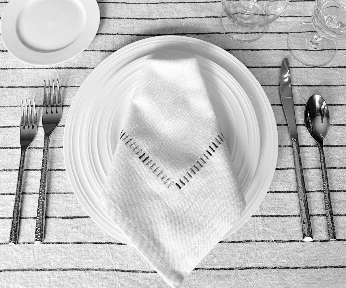 White dinner napkins for a formal and refined table setting White dinner napkins for a formal and refined table setting