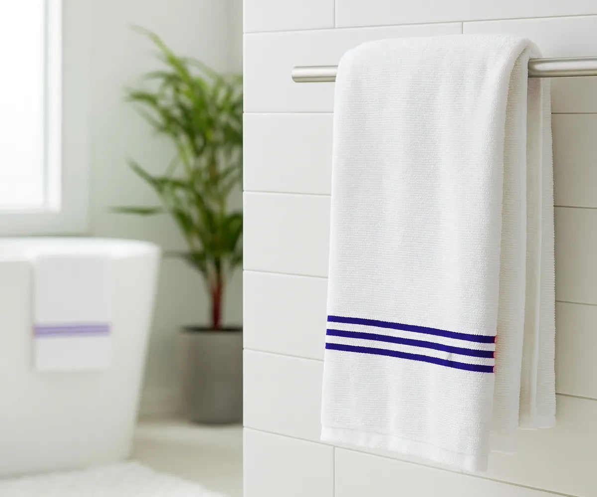 Luxury royal blue and white striped bath towel made from 100% premium cotton, featuring elegant royal blue embroidery — ultra-soft, absorbent, and perfect for home, spa, or gym use. Luxury royal blue and white striped bath towel made from 100% premium cotton, featuring elegant royal blue embroidery — ultra-soft, absorbent, and perfect for home, spa, or gym use.