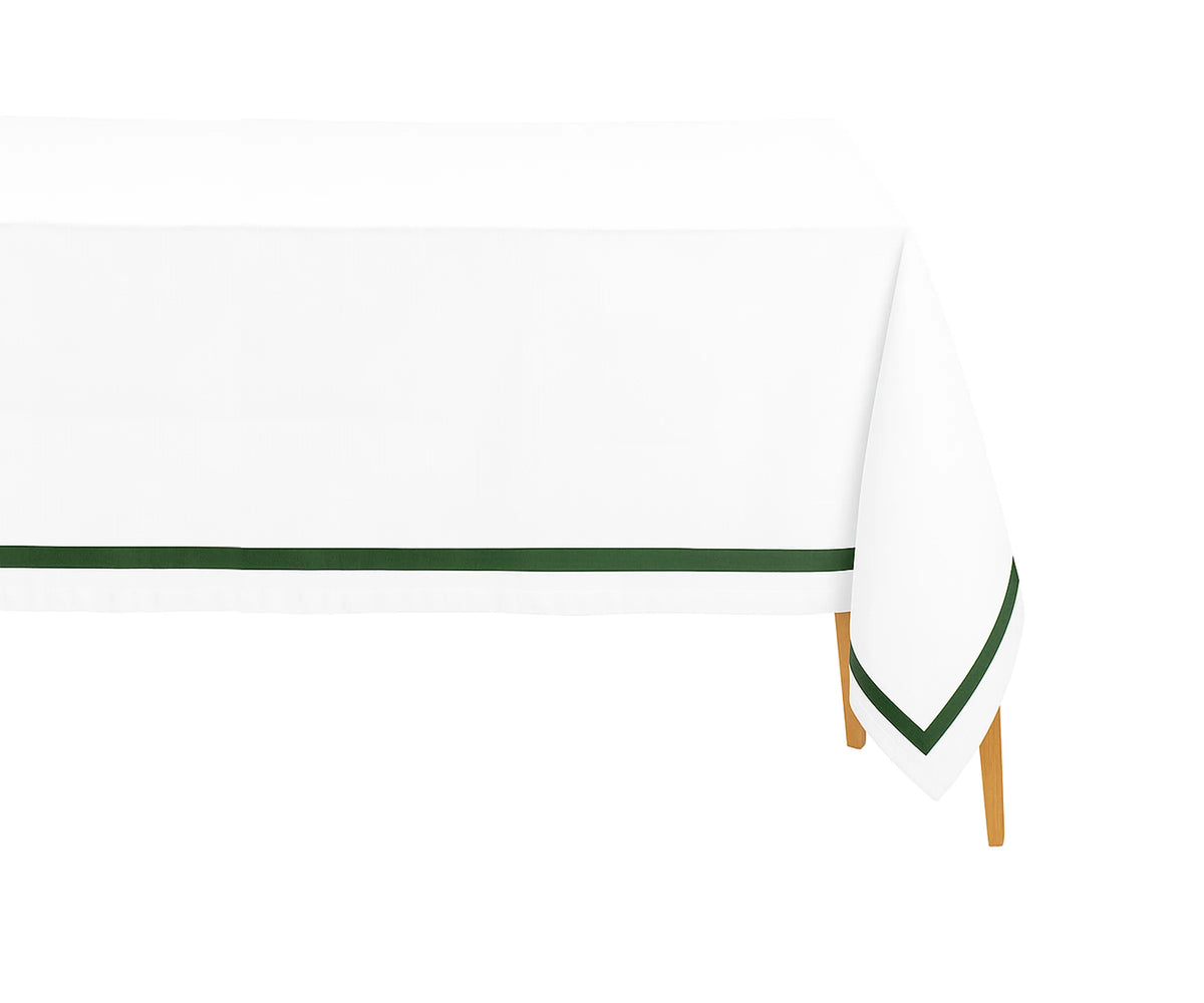 Green rectangle cotton tablecloth on dining table with neutral dinnerware Green rectangle cotton tablecloth on dining table with neutral dinnerware
