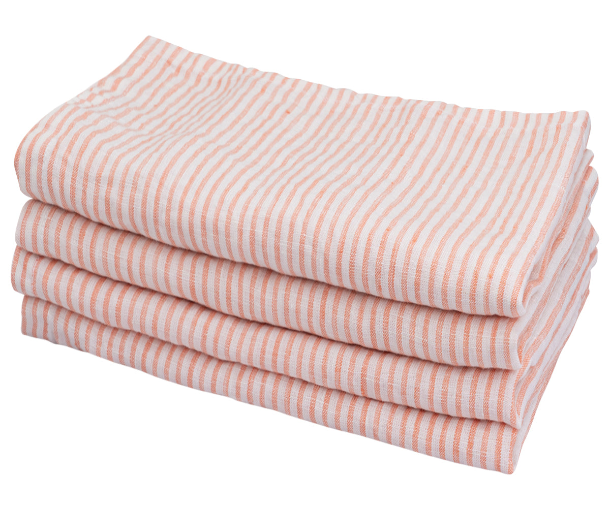 A neatly stacked set of Orange  and white linen striped napkins A neatly stacked set of Orange  and white linen striped napkins