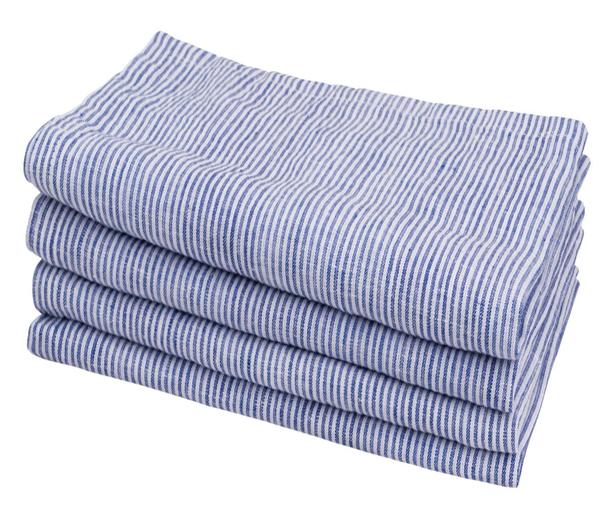 Multiple blue and white striped linen napkins in a symmetrical stack Multiple blue and white striped linen napkins in a symmetrical stack