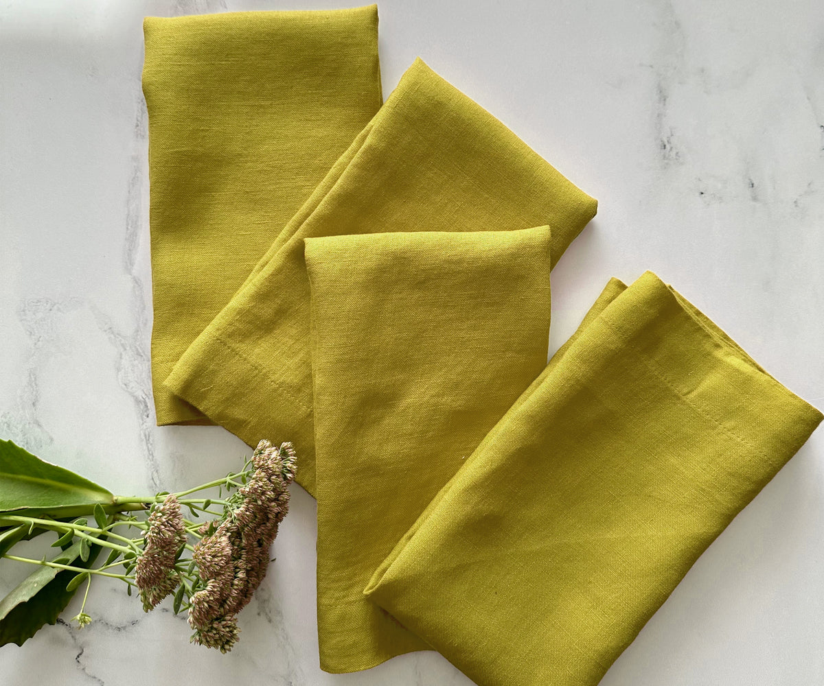 Bold yellow cloth napkin as part of a minimalist dining arrangement Bold yellow cloth napkin as part of a minimalist dining arrangement
