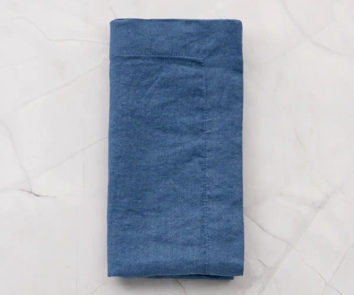 Folded navy blue table napkins made of linen Folded navy blue table napkins made of linen