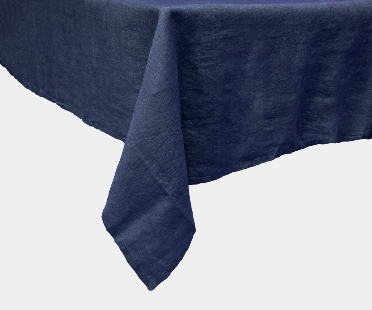 Blue linen tablecloth for a neutral and warm table setting. Blue linen tablecloth for a neutral and warm table setting.