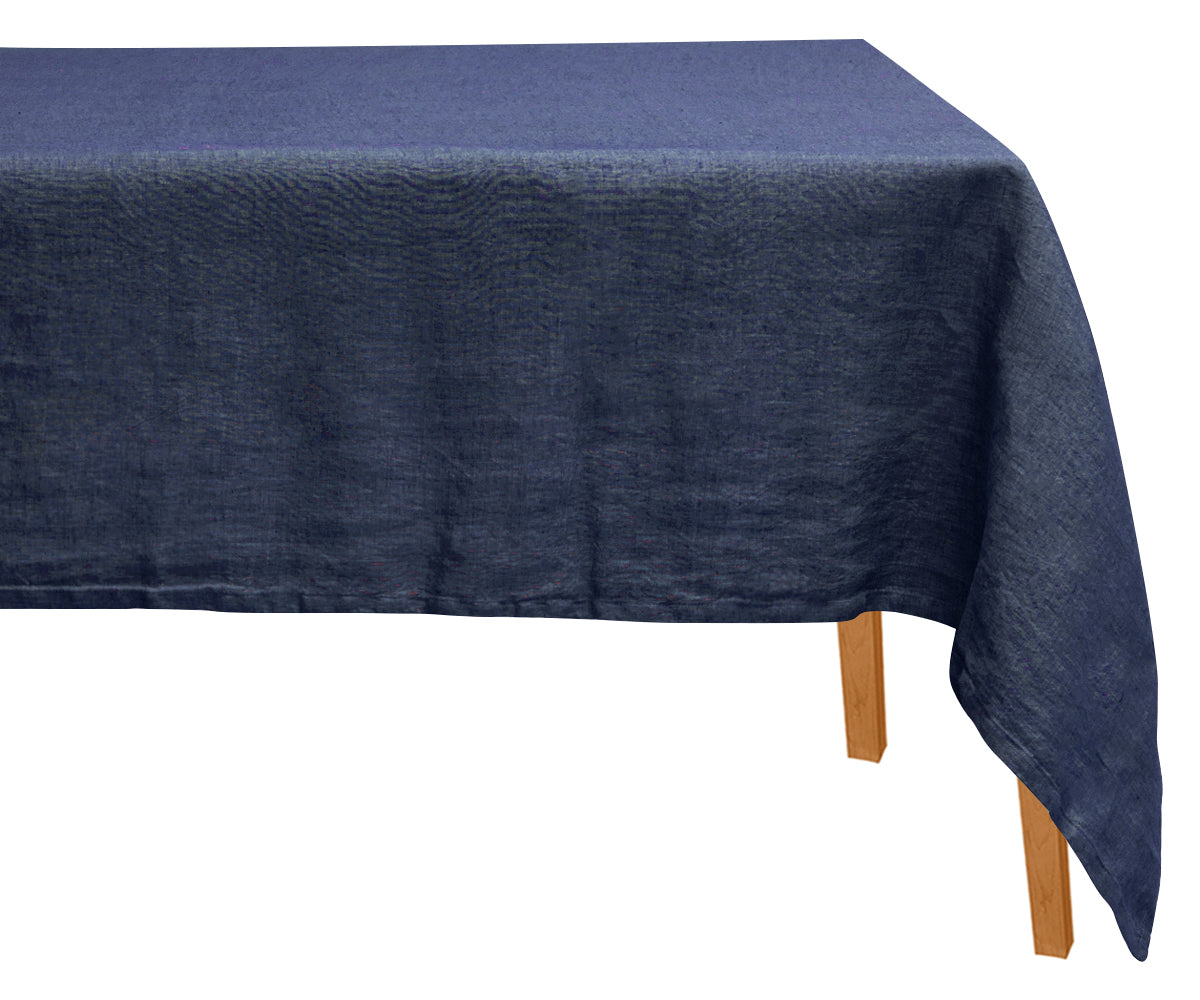 Plain blue linen tablecloth draped over a rectangular table. Plain blue linen tablecloth draped over a rectangular table.